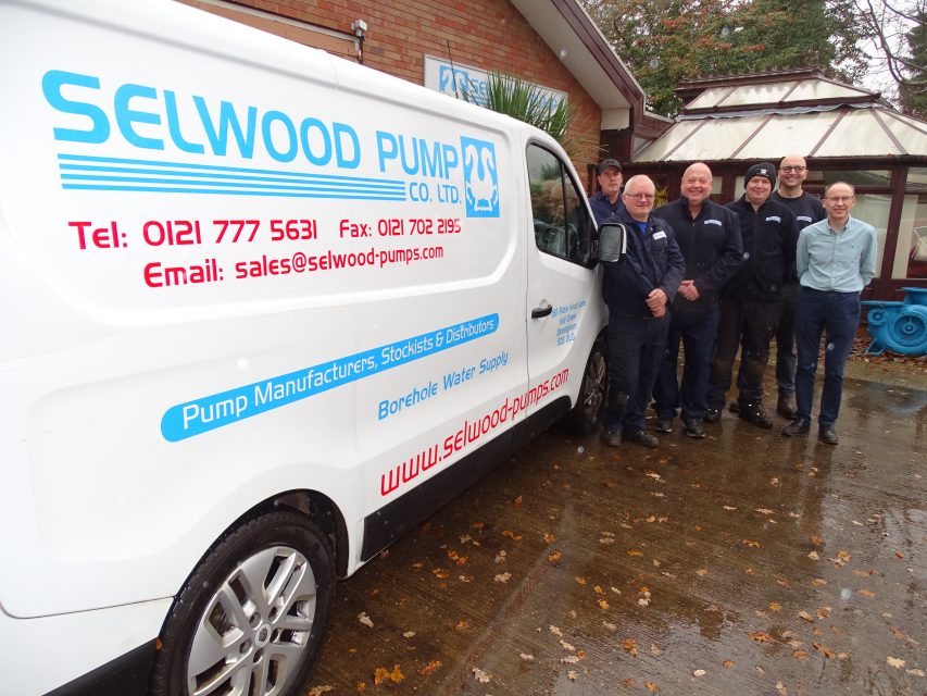 White van with Selwood's company logo with four men standing together next to it.